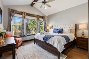 a bedroom with a bed and a chair and windows at Blanchard Bliss in Blanchard