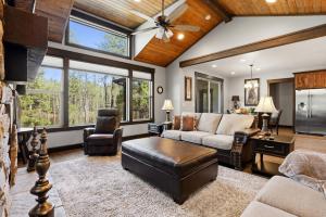 a living room with a vaulted ceiling with windows at Blanchard Bliss in Blanchard