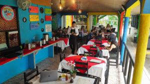 a restaurant with people sitting at tables at Hotel El Icaco Tortuguero in Tortuguero