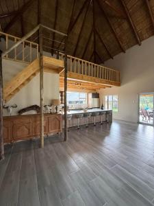 a large room with a loft bed and a wooden floor at Hemel Bushveld Lodge in Vaalwater