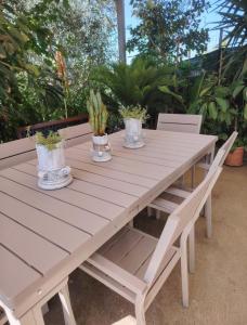a white picnic table with potted plants on it at Arco Antico in Grassano