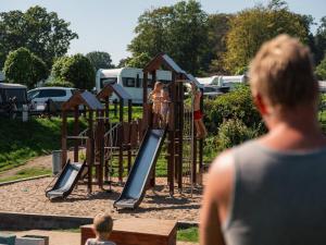 a group of people playing on a playground at DCU-Camping Grønninghoved Strand in Sjølund