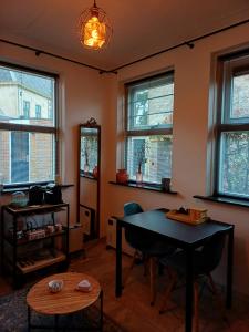 a living room with a table and some windows at De Allerhof in Hattem +11 photos