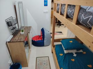 a room with two bunk beds and a table at Habitus in Shah Alam