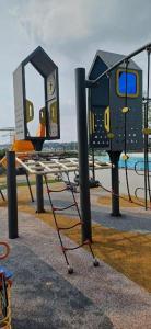 a playground with a table and a swing at Habitus in Shah Alam