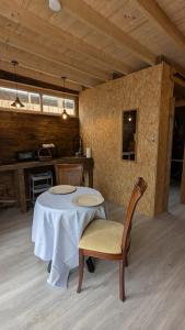 a dining room with a table and a kitchen at Bungalow TRADICIONS en FincaReal in Negreira +2 photos