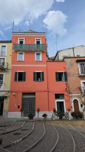 a orange building on the side of a street at Agli Archi Eco House in Chieti