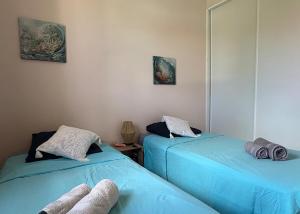 two beds sitting next to each other in a room at Grain de Corail in Saint-François +20 photos