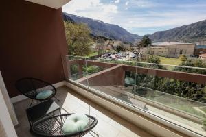 a balcony with chairs and a view of the mountains at Adria Gold - Bayview - Luxury in Kotor