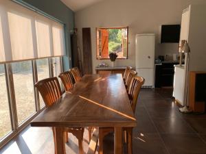 a dining room with a wooden table and chairs at Maison de l'Hermitage in Cucuron