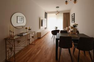 a living room with a table and a dining room at Adria Gold - Bayview - Luxury in Kotor