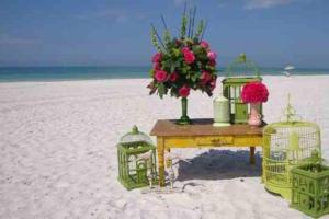 a table with a bouquet of flowers on the beach at Sunny PaG Island rental wbikes-just steps2beach in St. Pete Beach