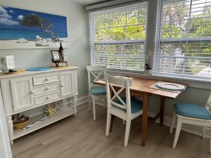 a dining room with a table and chairs and a desk at Sunny PaG Island rental wbikes-just steps2beach in St. Pete Beach