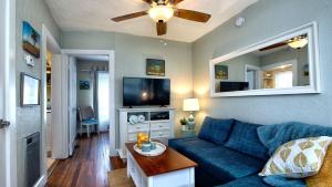 a living room with a blue couch and a flat screen tv at Sunny PaG Island rental wbikes-just steps2beach in St. Pete Beach +24 photos