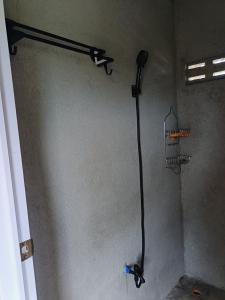 a shower in the corner of a room at Maybeth Haven Cabin in Baler