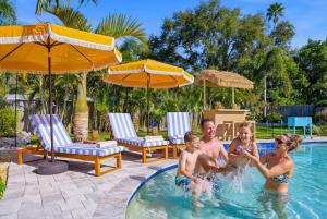 a family playing in a swimming pool at Resort Style Backyard Pool Hot Tub Games in Seminole