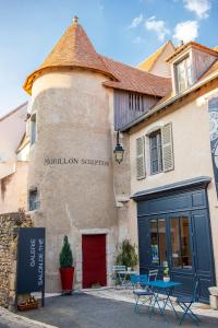 a building with a sign on the side of it at Chambres d'hôtes de La Tour Morillon in Saint-Amand-Montrond
