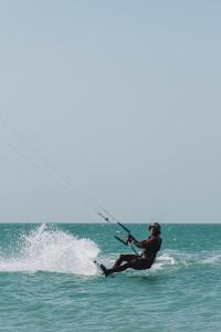 a person in the water holding on to a rope at Playa Escondida Mayapo in Mayapo