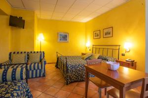 a hotel room with a bed and a table at Albergo Ristorante Badellino dal 1917 in Bra