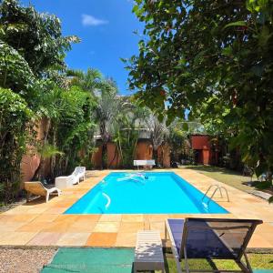 a swimming pool in a yard with trees at Recanto do Capitão in Rio de Janeiro