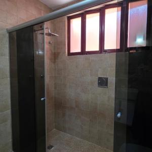 a shower with a glass door in a bathroom at Recanto do Capitão in Rio de Janeiro +17 photos