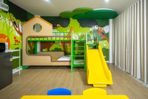 a childs room with a slide and a bunk bed at KYP Hotel โรงแรมขุนยูวเพลส in Fang