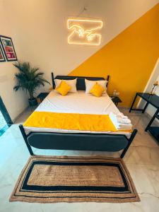 a large bed in a room with a yellow wall at Bingo Service Apartment Grand 3BHK in Alwar