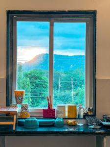 a kitchen counter with a view of a window at Bingo Service Apartment Grand 3BHK in Alwar