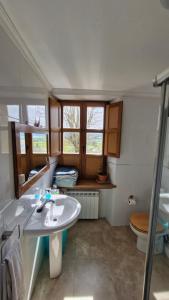 a bathroom with a sink and a toilet at Rural house in Villabasil +42 photos