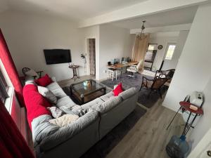 a living room with a white couch with red pillows at Large King Suite Completely Private Space Stay close enough to Newport without the Noise in Portsmouth
