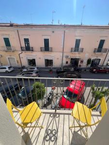 a balcony with two chairs and a parking lot at Mare guest house in Termoli