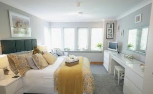 a living room with a couch and a desk at The Nest - Chandlers in Rothesay