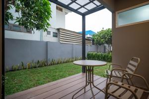 a patio with a table and chairs on a deck at KYP Hotel โรงแรมขุนยูวเพลส in Fang