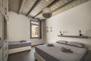 a bedroom with two beds and a window at Rada Residence in Livadi