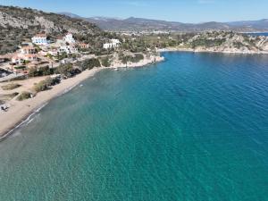 an aerial view of a beach with blue water at Captain's Tolo Sea View 2 in Tolo +21 photos