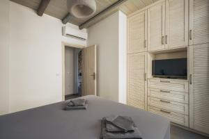 a bedroom with a large bed with a tv on it at Rada Residence in Livadi