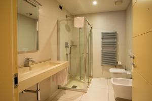 a bathroom with a sink and a shower and a toilet at Albergo Ristorante Badellino dal 1917 in Bra +76 photos
