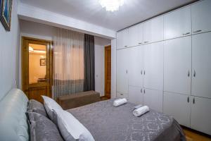 a bedroom with a bed with two towels on it at Cozy Apartment on Kostava in Tbilisi City