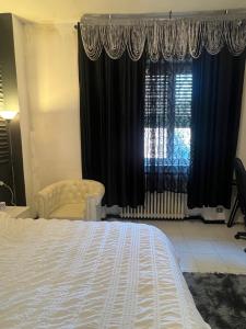 a bedroom with a large bed and a window at private room in a shared apartment in Seveso