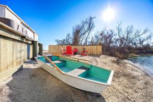 a boat sitting on the shore next to a building at 5066 - McBride's Shore Thing 2 in Kill Devil Hills +62 photos
