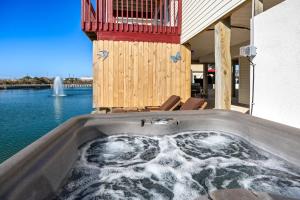a hot tub on a house next to the water at 5066 - McBride's Shore Thing 2 in Kill Devil Hills