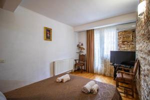 a bedroom with a bed with towels on it at Cozy Apartment on Kostava in Tbilisi City