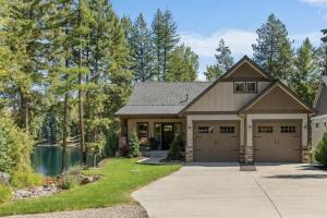a house with a garage and a lake at Blanchard Bliss in Blanchard