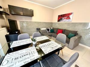 a living room with a table and chairs and a couch at Dorina wellness in Siófok +75 photos