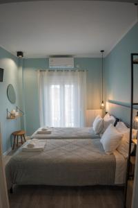 a bedroom with a large bed and a window at Diamanti Studios in Skala Kallonis
