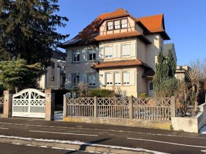 a house with a white fence in front of it at Maison de maitre a Strasbourg illkirch 3 chambres in Illkirch-Graffenstaden