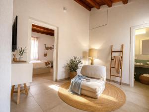 a living room with a chair and a television at Hotel PI Arte Exclusive Suite in Palermo