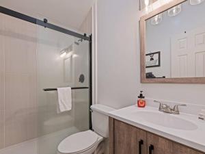 a bathroom with a toilet and a sink and a mirror at Kabin Kleighp Maggie Valley in Maggie Valley +23 photos
