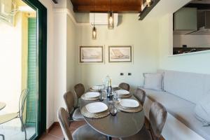 a dining room with a table and chairs at Stunning lake view, Cernobbio in Cernobbio