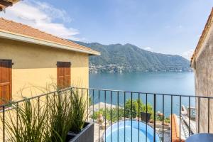 a balcony with a view of a body of water at Stunning lake view, Cernobbio in Cernobbio